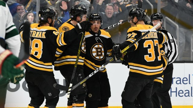 Boston Bruins left wing Brad Marchand (63) and teammates