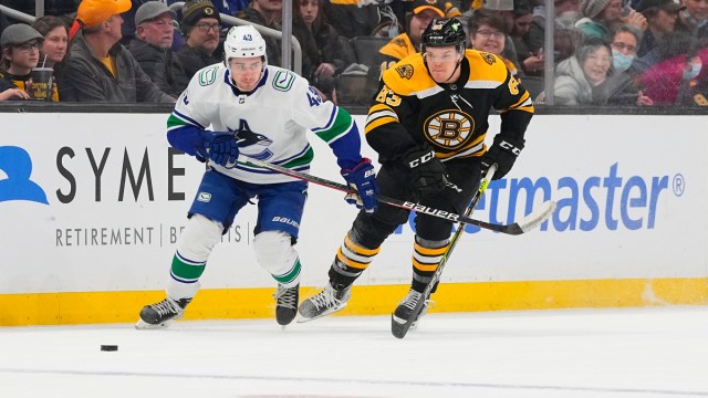 Boston Bruins winger Karson Kuhlman, Vancouver Canucks defenseman Quinn Hughes