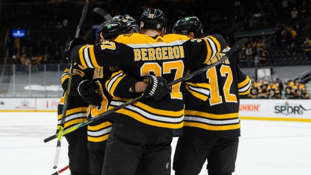 Boston Bruins players celebrate against the Pittsburgh Penguins