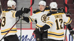 Boston Bruins left wing Trent Frederic (11), center Charlie Coyle (13) and right wing Craig Smith (12)