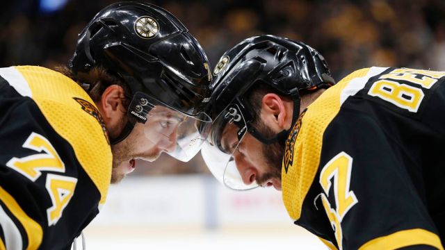 Boston Bruins winger Jake DeBrusk, center Patrice Bergeron