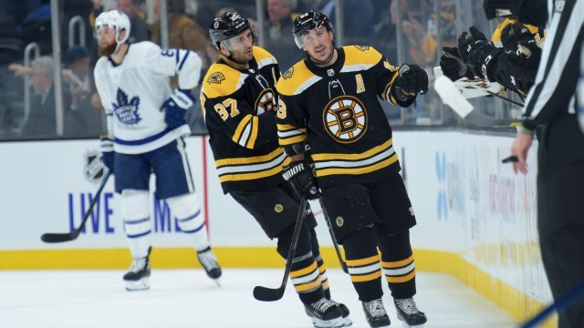 Boston Bruins left wing Brad Marchand (63) and center Patrice Bergeron (37) celebrate against the Toronto Maple Leafs