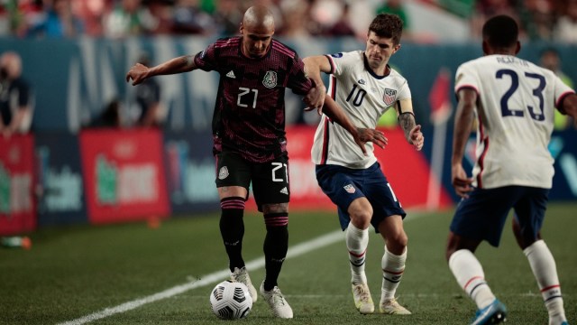 Mexico defender Luis Rodriguez (21) and United States forward Christian Pulisic (10) and midfielder Kellyn Acosta (23)