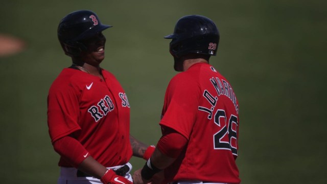 Boston Red Sox third baseman Rafael Devers (left) and designated hitter J.D. Martinez