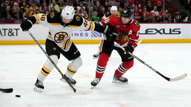 Boston Bruins defenseman Matt Grzelcyk, Chicago Blackhawks right wing Patrick Kane