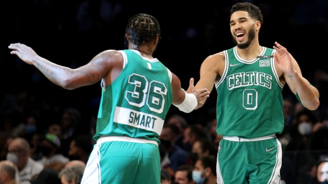 Boston Celtics forward Jayson Tatum (0) and guard Marcus Smart (36) celebrate against the Brooklyn Nets