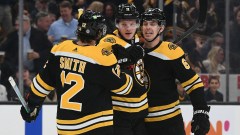 Bruins left wing Trent Frederic (11), right wing Craig Smith (12) and defenseman Mike Reilly (6) celebrate after Boston scored against the Pittsburgh Penguins