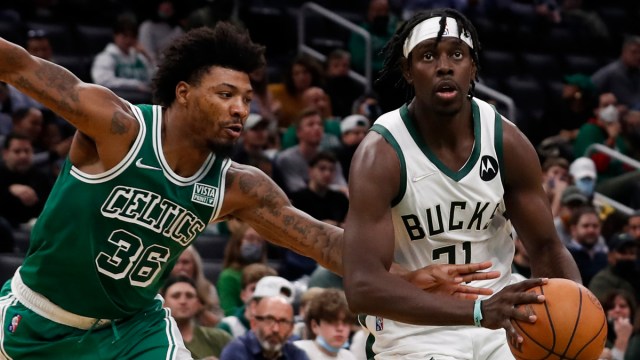 Boston Celtics guard Marcus Smart defending Milwaukee Bucks guard Jrue Holiday