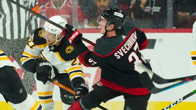 Boston Bruins defenseman Hampus Lindholm, Carolina Hurricanes right win Andrei Svechnikov