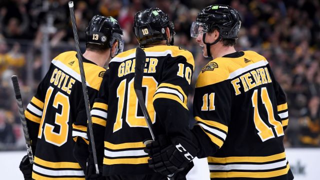 Boston Bruins forwards A.J. Greer, Charlie Coyle, Trent Frederic