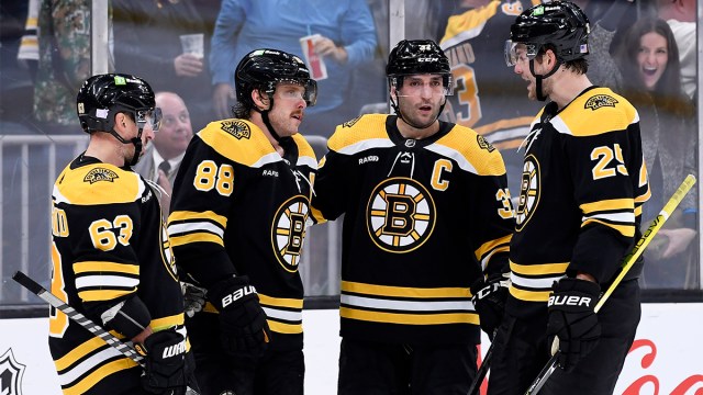 Boston Bruins forwards David Pastrnak, Patrice Bergeron, and Brad Marchand