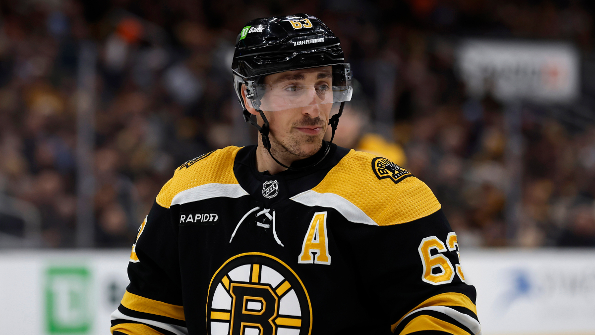 Looks like Marchand is using his black gloves with some kind of