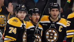 Boston Bruins forwards Jake DeBrusk, Brad Marchand and Patrice Bergeron