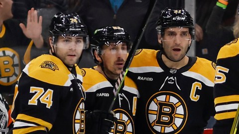 Boston Bruins forwards Jake DeBrusk, Brad Marchand and Patrice Bergeron