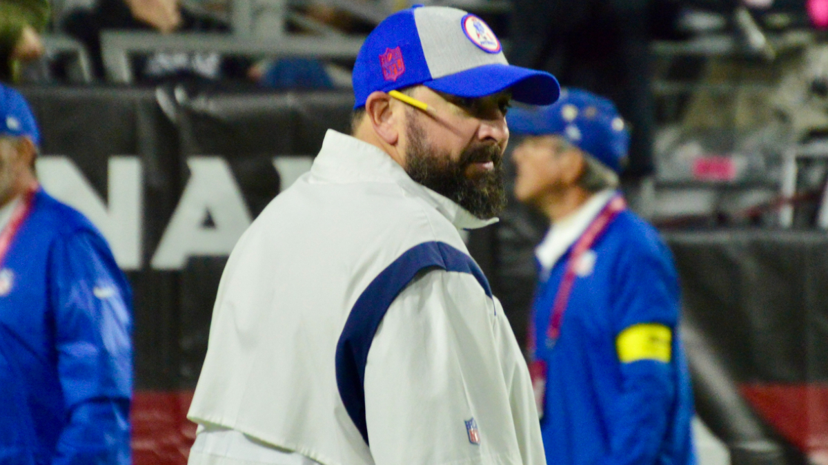 New England Patriots assistant coach Matt Patricia makes a play call on the  sideline while wearing in Italian flag on his shirt during the first half  of an NFL football game against