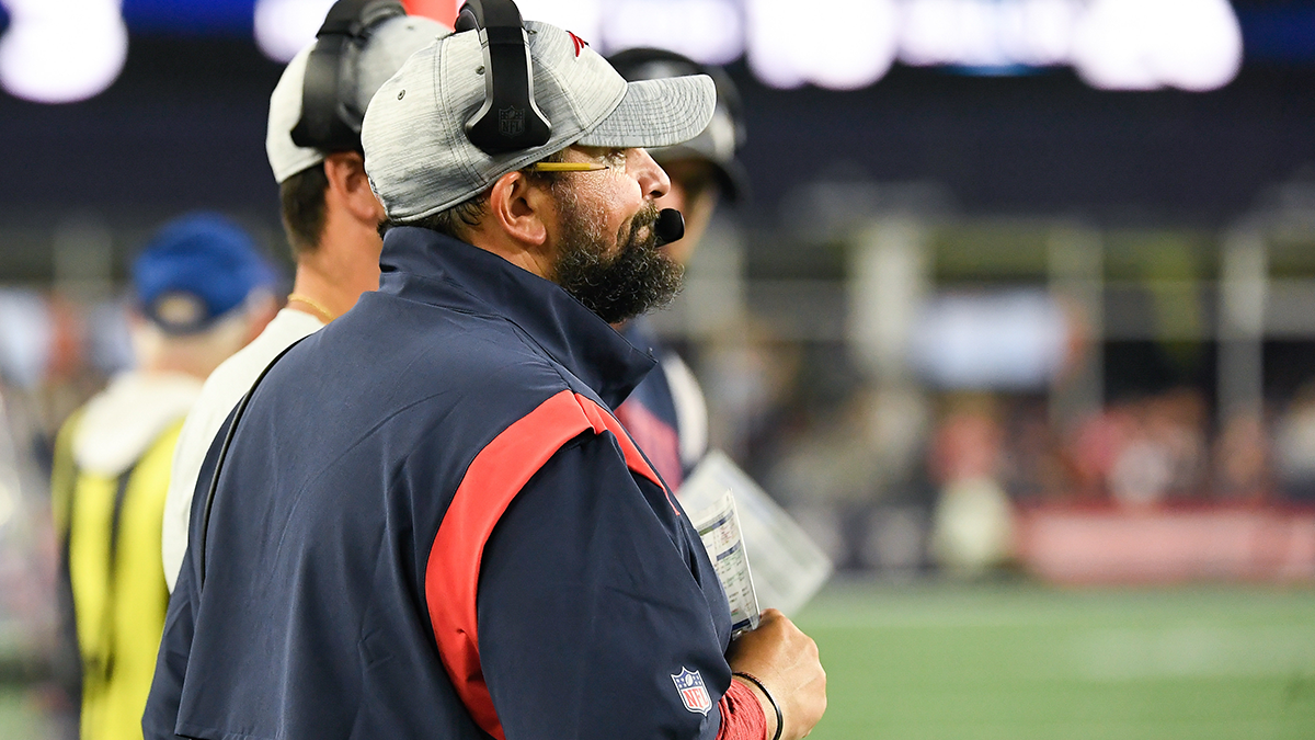 New England Patriots assistant coach Matt Patricia makes a play call on the  sideline while wearing in Italian flag on his shirt during the first half  of an NFL football game against