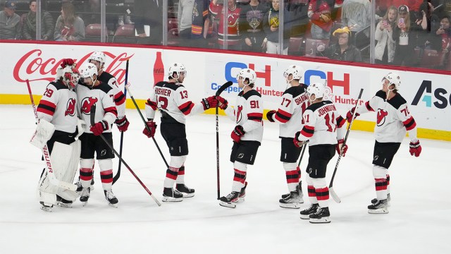 New Jersey Devils teammates celebrate on ice