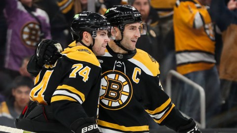 Boston Bruins forwards Jake DeBrusk and Patrice Bergeron