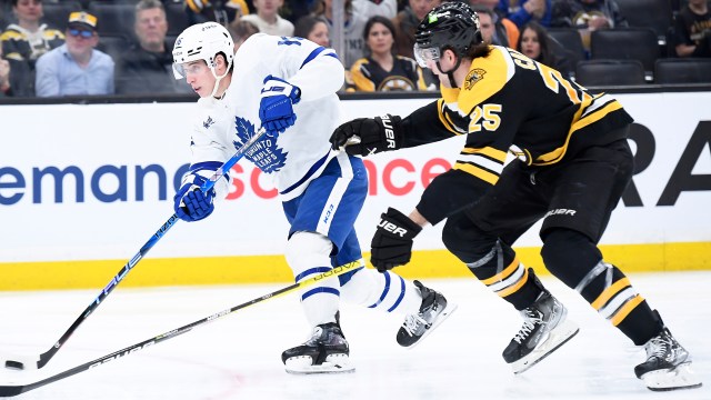 Boston Bruins defenseman Charlie McAvoy (73) is helped off the ice after  being hurt crashing into the dasher during the third period of an NHL  hockey game against the Tampa Bay Lightning