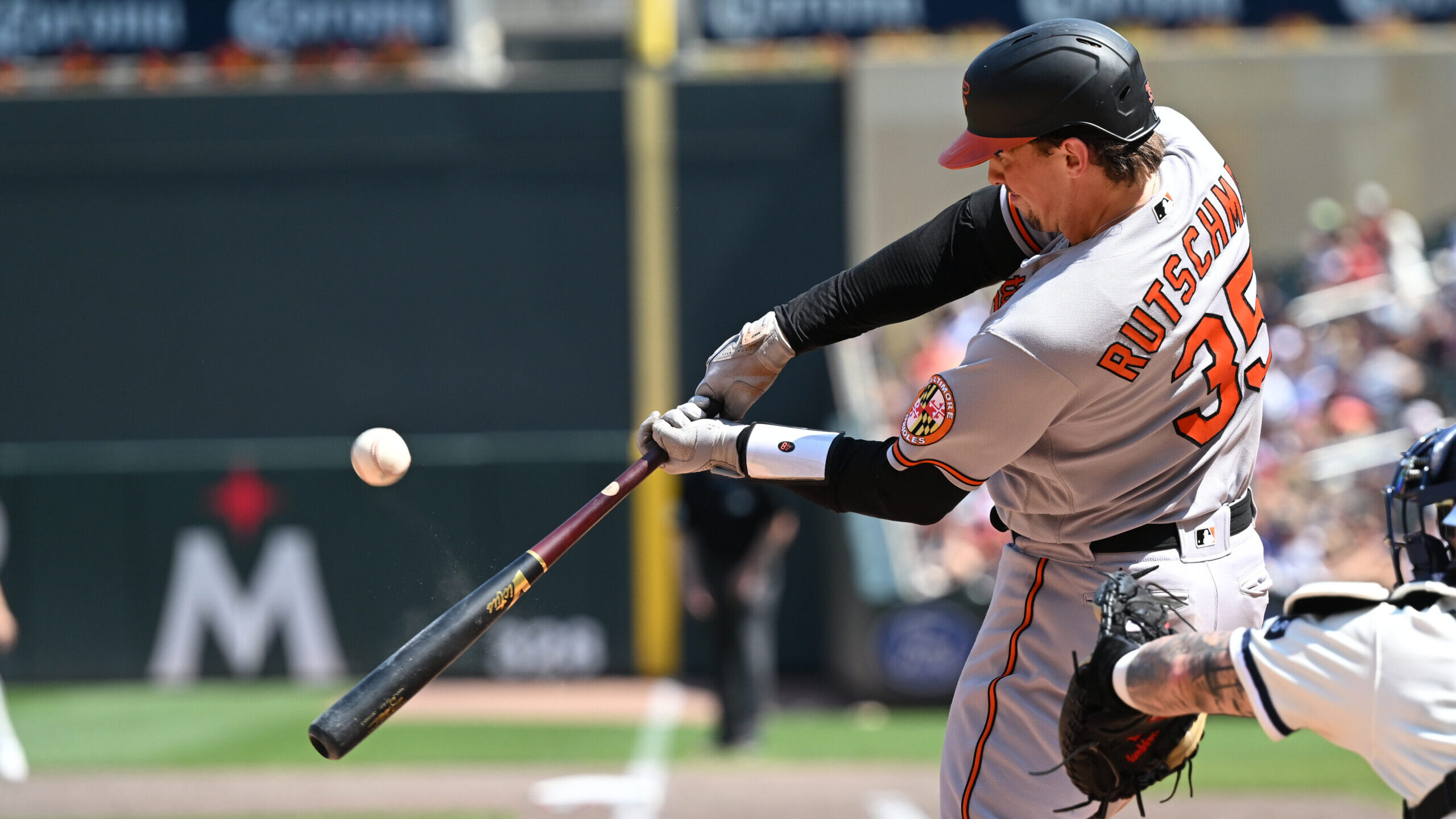 Download Adley Rutschman Swinging For The Baltimore Orioles Wallpaper