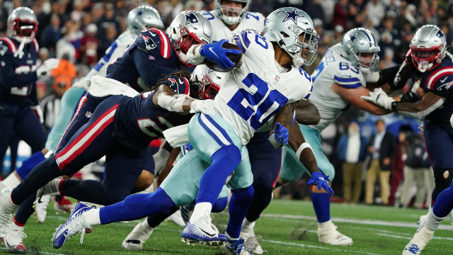 Dallas Cowboys running back Tony Pollard rushing against New England Patriots defense
