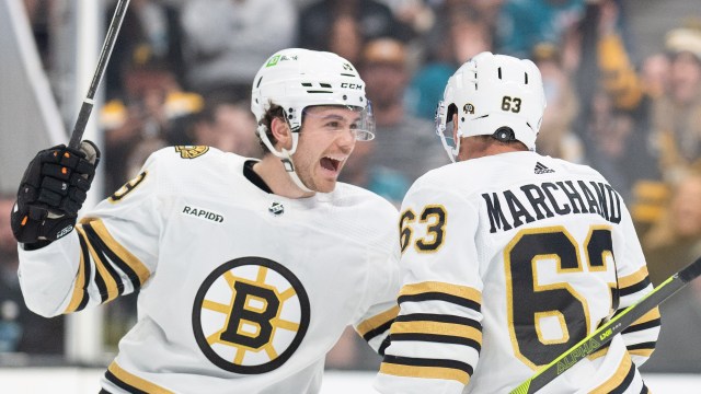 Boston Bruins forwards Johnny Beecher and Brad Marchand