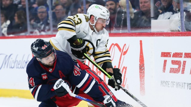 Boston Bruins forward Brad Marchand and Winnipeg Jets defenseman Josh Morrissey