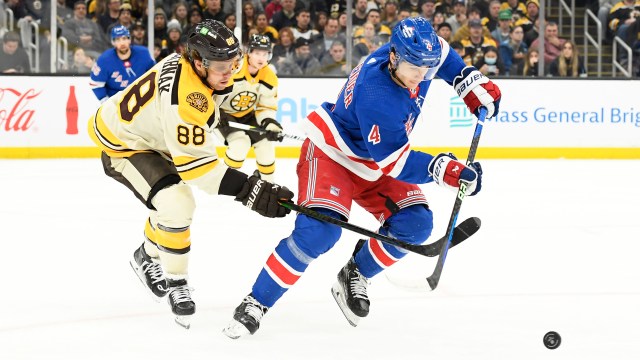 Boston Bruins right wing David Pastrnak and New York Rangers defenseman Braden Schneider