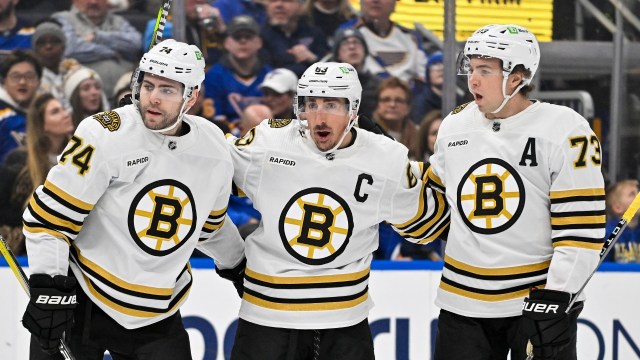 Boston Bruins forwards Jake DeBrusk and Brad Marchand and defenseman Charlie McAvoy