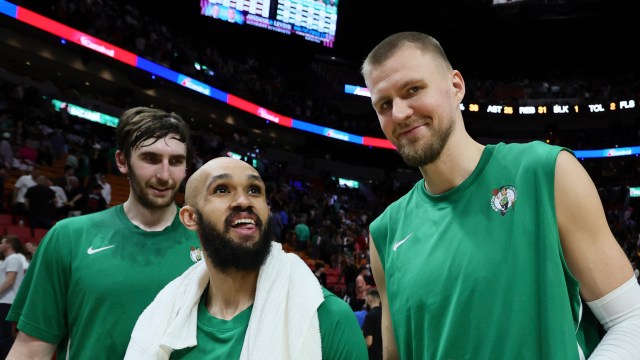 Boston Celtics teammates Kristaps Porzingis, Derrick White and Luke Kornet