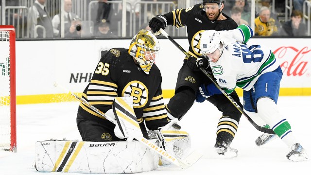 Boston Bruins goalie Linus Ullmark and defenseman Matt Grzelcyk and Vancouver Canucks center Nils Aman