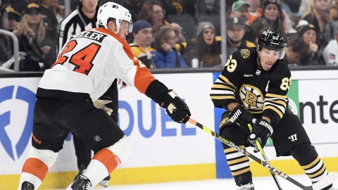 Philadelphia Flyers defenseman Nick Seeler, Boston Bruins forward Brad Marchand