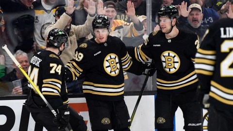 Boston Bruins forwards Jake DeBrusk and Morgan Geekie and defenseman Brandon Carlo