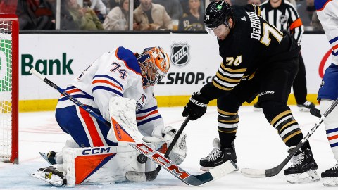 Boston Bruins forward Jake DeBrusk and Edmonton Oilers goalie Stuart Skinner