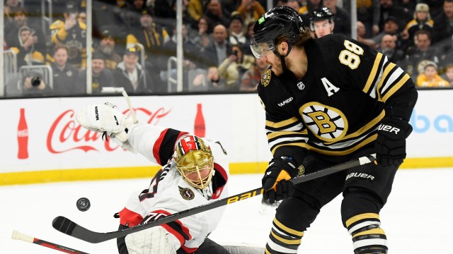 Boston Bruins forward David Pastrnak and Ottawa Senators goaltender Joonas Korpisalo