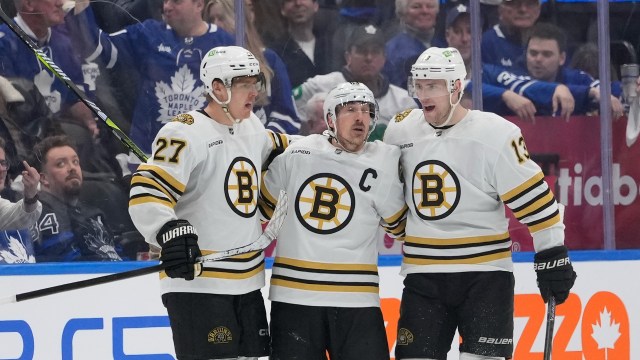 Boston Bruins defenseman Hampus Lindholm and forwards Brad Marchand and Charlie Coyle