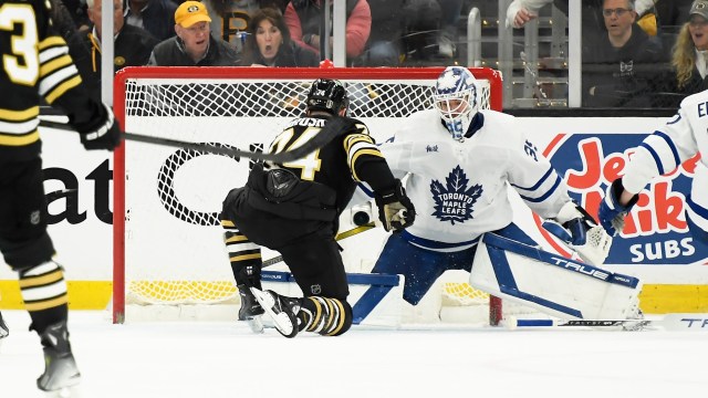 Boston Bruins forward Jake DeBrusk and Toronto Maple Leafs goaltender Ilya Samsanov