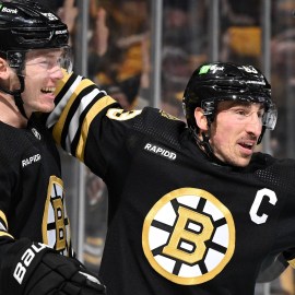 Boston Bruins forwards Morgan Geekie, Brad Marchand