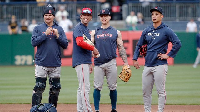 Boston Red Sox catcher Reese McGuire, base coach Kyle Hudson, and outfielders Tyler O'Neill and Rob Refsnyder