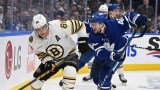 Boston Bruins forward David Pastrnak, Toronto Maple Leafs defenseman Ilya Lyubushkin