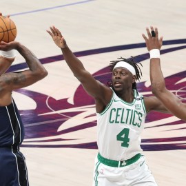 Dallas Mavericks guard Kyrie Irving and Boston Celtics teammates Jrue Holiday and Jaylen Brown