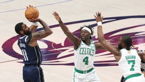 Dallas Mavericks guard Kyrie Irving and Boston Celtics teammates Jrue Holiday and Jaylen Brown
