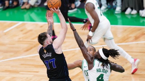 Dallas Mavericks guard Luka Doncic and Boston Celtics teammates Al Horford and Jrue Holiday