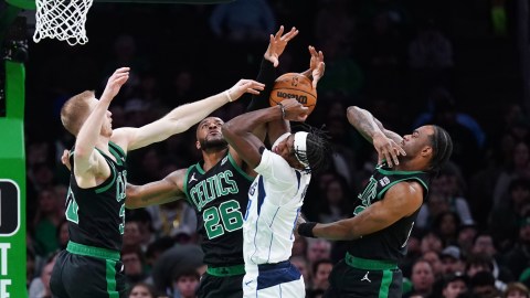 Boston Celtics teammates Sam Hauser, Xavier Tillman Sr., and Oshae Brissett