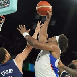 Team USA guard Stephen Curry and forward LeBron James and Team France forward Guerschon Yabusele