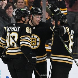 Boston Bruins forwards David Pastrnak, Charlie Coyle and Brad Marchand