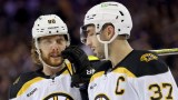 Boston Bruins forward David Pastrnak, retired NHL forward Patrice Bergeron