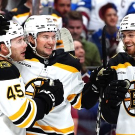 Boston Bruins forwards Cole Koepke and Johnny Beecher and defenseman Andrew Peeke