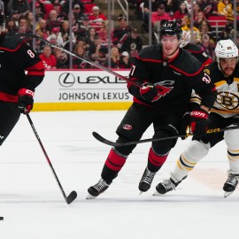 Boston Bruins forward David Pastrnak and Carolina Hurricanes defenseman Brent Burns and forward Andrei Svechnikov