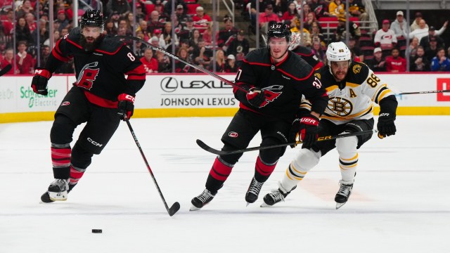 Boston Bruins forward David Pastrnak and Carolina Hurricanes defenseman Brent Burns and forward Andrei Svechnikov